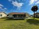 View of backyard with screened-in porch and chain-link fence at 6113 Mckee St, Port Charlotte, FL 33981