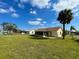 Large grassy backyard with a screened-in porch perfect for entertaining at 6113 Mckee St, Port Charlotte, FL 33981