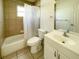 Neutral bathroom features a shower/tub combo, toilet, sink and large mirror at 6113 Mckee St, Port Charlotte, FL 33981