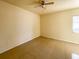 Bright bedroom featuring tile flooring, ceiling fan, and a large window at 6113 Mckee St, Port Charlotte, FL 33981