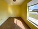 Cozy bedroom filled with sunlight showcasing neutral walls and tile flooring at 6113 Mckee St, Port Charlotte, FL 33981