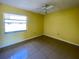 Sunny bedroom with tile floors and a ceiling fan to keep cool during the summer at 6113 Mckee St, Port Charlotte, FL 33981
