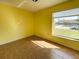 Sunny bedroom featuring tile flooring and a large window with a neighborhood view at 6113 Mckee St, Port Charlotte, FL 33981