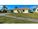 Charming home with neat front lawn and mature shrubs under blue sky at 6113 Mckee St, Port Charlotte, FL 33981