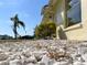 Exterior angle from the ground showing rock landscaping and house details at 6113 Mckee St, Port Charlotte, FL 33981