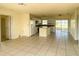 Open-concept kitchen featuring an island, white cabinets and tiled floors at 6113 Mckee St, Port Charlotte, FL 33981