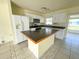 Bright kitchen features white cabinets, modern appliances and a cozy breakfast bar at 6113 Mckee St, Port Charlotte, FL 33981
