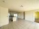 Open living space featuring a view of the kitchen, tiled floor, and natural lighting at 6113 Mckee St, Port Charlotte, FL 33981