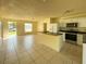 Bright living room featuring an open floor plan and a breakfast bar, ideal for gathering and dining at 6113 Mckee St, Port Charlotte, FL 33981