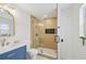 This bathroom has a blue vanity, gold fixtures, and an updated shower with a glass door at 612 65Th W Ave, Bradenton, FL 34207