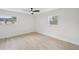 Bright, minimalist bedroom features hardwood floors and two windows with ample natural light at 612 65Th W Ave, Bradenton, FL 34207