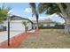 Charming single-story home features a well-maintained lawn, palm trees, and an attached two-car garage at 612 65Th W Ave, Bradenton, FL 34207