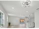 Bright, open floor plan featuring modern lighting fixtures, hardwood floors, and a view of the pool at 612 65Th W Ave, Bradenton, FL 34207