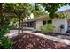 Backyard with paved patio and pergola, view of the house and screened in patio at 6512 Bowline Dr, Sarasota, FL 34231