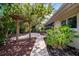 Backyard with paved patio and pergola, view of the house and screened in patio at 6512 Bowline Dr, Sarasota, FL 34231