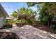 Backyard brick patio area under a pergola surrounded by lush greenery at 6512 Bowline Dr, Sarasota, FL 34231