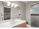 Bathroom with a sink, white countertop, and a walk-in shower at 6512 Bowline Dr, Sarasota, FL 34231