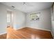 Neutral bedroom with hardwood floors, a window, and an ensuite bathroom at 6512 Bowline Dr, Sarasota, FL 34231