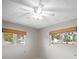 A bedroom with a ceiling fan and two windows at 6512 Bowline Dr, Sarasota, FL 34231