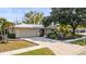 Charming single-story home with a paved driveway, attached garage, and well-maintained landscaping at 6512 Bowline Dr, Sarasota, FL 34231
