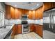 Updated kitchen boasts stainless steel appliances, granite countertops, custom cabinets, and modern lighting fixtures at 6512 Bowline Dr, Sarasota, FL 34231