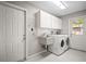 Laundry room with sink, cabinets, and appliances at 6512 Bowline Dr, Sarasota, FL 34231