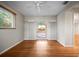 Bright living room with hardwood floors and sliding glass doors to the outdoor patio at 6512 Bowline Dr, Sarasota, FL 34231