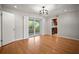 Spacious living room boasts hardwood floors, access to the kitchen, and sliding glass doors leading to the outdoors at 6512 Bowline Dr, Sarasota, FL 34231