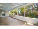 Wide view of screened patio, ceiling fans, and landscaped backyard at 6512 Bowline Dr, Sarasota, FL 34231