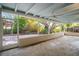 Spacious screened patio with ceiling fans and views of the landscaped backyard at 6512 Bowline Dr, Sarasota, FL 34231
