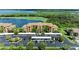 Aerial view showcases the community's waterfront property, manicured landscaping, and ample parking at 6519 Grand Estuary Trl # 107, Bradenton, FL 34212