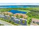 Scenic aerial view of waterfront property with lush landscaping, golf course, and well-maintained buildings at 6519 Grand Estuary Trl # 107, Bradenton, FL 34212