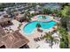 This is an aerial view of the pool, tennis courts, and cabana at 6519 Grand Estuary Trl # 107, Bradenton, FL 34212