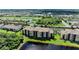 Scenic aerial view of condo building with golf course and lakes in a well-manicured community at 6519 Grand Estuary Trl # 107, Bradenton, FL 34212