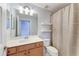 Traditional bathroom with wooden vanity, large mirror, and shower featuring decorative curtain at 6519 Grand Estuary Trl # 107, Bradenton, FL 34212