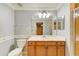 Well-lit bathroom with a wood vanity, large mirror, and separate tiled shower with glass doors at 6519 Grand Estuary Trl # 107, Bradenton, FL 34212