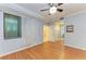 Bright bedroom with hardwood floors and a window with blinds, offering a comfortable space at 6519 Grand Estuary Trl # 107, Bradenton, FL 34212