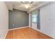 Modern bedroom with hardwood floors, a window with blinds, and neutral-colored walls at 6519 Grand Estuary Trl # 107, Bradenton, FL 34212