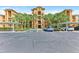 Building exterior featuring well-manicured landscaping, covered parking and accessible parking at 6519 Grand Estuary Trl # 107, Bradenton, FL 34212