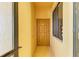 Apartment entrance featuring a sturdy wooden door and window with blinds, providing security and natural light at 6519 Grand Estuary Trl # 107, Bradenton, FL 34212