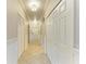 Bright hallway featuring tile floors, crisp white trim, and convenient closet space at 6519 Grand Estuary Trl # 107, Bradenton, FL 34212
