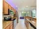 Bright kitchen with stainless steel appliances, granite countertops and a breakfast nook with a view at 6519 Grand Estuary Trl # 107, Bradenton, FL 34212
