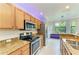 Bright kitchen with stainless steel appliances, granite countertops and a breakfast nook with a view at 6519 Grand Estuary Trl # 107, Bradenton, FL 34212
