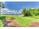 Scenic lake view with lush greenery and serene water at 6519 Grand Estuary Trl # 107, Bradenton, FL 34212