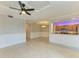 Open living room boasts modern fan, tray ceiling, and seamless flow to the kitchen at 6519 Grand Estuary Trl # 107, Bradenton, FL 34212