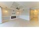 Living room with coffered ceilings, modern fan and built-in shelving with fireplace at 6519 Grand Estuary Trl # 107, Bradenton, FL 34212