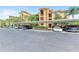 Designated covered parking area with ample space and greenery surrounding the residential buildings at 6519 Grand Estuary Trl # 107, Bradenton, FL 34212