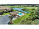 Community pool with sun loungers, lush greenery, and a covered pavilion at 6519 Grand Estuary Trl # 107, Bradenton, FL 34212
