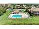 Aerial view of a community pool with lounge chairs and gazebo, creating an inviting outdoor space at 6519 Grand Estuary Trl # 107, Bradenton, FL 34212