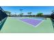 Exterior view of community tennis and pickleball courts surrounded by palm trees at 6519 Grand Estuary Trl # 107, Bradenton, FL 34212